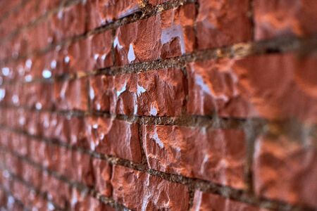 Loft red brick wall, angled view. Polished brick wall in attic interior. Background texture for...