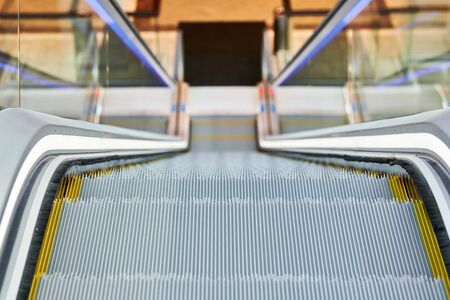 Escalator in shopping center. Close up escalators stairs up and down in office building, shopping...