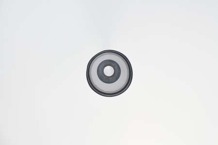 Modern white chandelier, minimal background. Ceiling lamp and lampshade in apartment for rent.