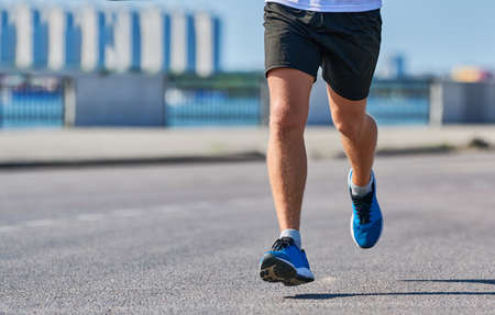 Running man. Athletic man jogging in sportswear on city road. Healthy lifestyle, fitness sport...
