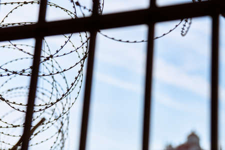 Barbed wire on prison fence. Restricted access from restricted area. Security guardの写真素材