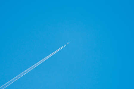 Airplane in sky, centered. Little plane, clear blue background. Minimalistic