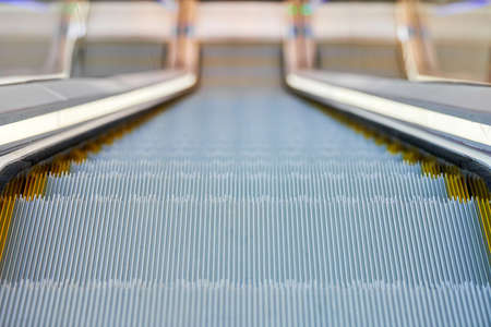 Escalator in business center. Close up escalators stairs up and down in office building, shopping...