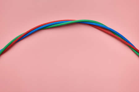 Nylon twisted ropes tied the knot. Red, green and blue ropes. Strong and reliable fastening for...