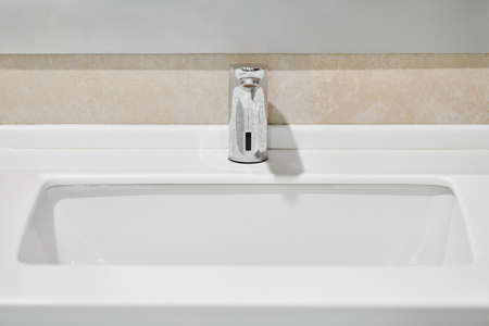 Faucet in bathroom interior. Water tap for washing hands. Sanitary prevention antivirus concept.