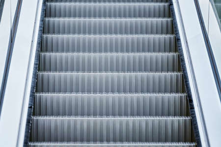 Escalator in shopping center. Close up escalators stairs up and down in office building, shopping...