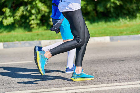 Running women. Sport women jogging in sportswear on city road. Healthy lifestyle, fitness hobby....