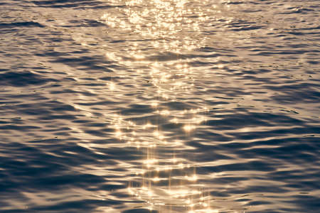 Ocean water texture in sunlight. Slight flow and light wind on water surface. Sunny natural ocean...