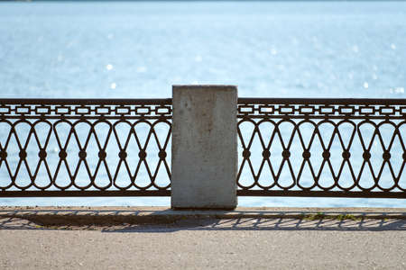 Iron fencing on waterfront. Riverside decor fence. Outdoor urban pathway for walking with enclosureの写真素材