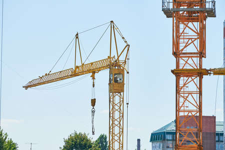 Construction crane working on building complex. Election new shopping center in city downtown....
