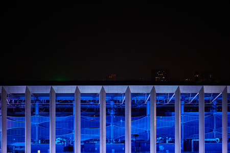 Stadium night lights, close up. Blue lighting of sports facility. Football stadium building at...