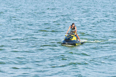 Voronezh, Russia - 23.08.2019 - Man on water scooter. Summer vacation on personal watercraft in tropical sea. Young guy sea riding hobby. PWC sport activityのeditorial素材