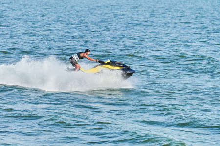 Voronezh, Russia - 23.08.2019 - Man on water scooter. Summer vacation on personal watercraft in tropical sea. Young guy sea riding hobby. PWC sport activityのeditorial素材