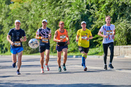 Voronezh, Russia - 08.24.2019 - Marathon runners on city road. Running competition, copy space....