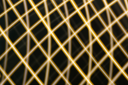 Abstract light background. Yellow blured trail lights, strips and bokeh. Beautiful motion painting. Long exposure photographyの写真素材