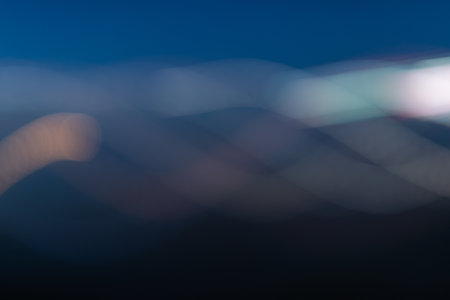 Abstract light background. Blue blured trail lights, strips and bokeh. Beautiful motion painting. Long exposure photographyの写真素材