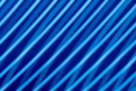 Abstract light background. Blue blured trail lights, strips and bokeh. Beautiful motion painting....