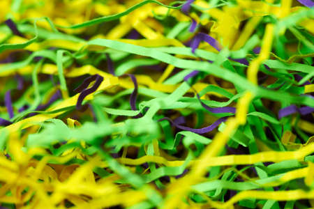 Colorful tinsel, party holiday background. Gift box decorative filler. Beautiful backdrop design for advertising.の写真素材