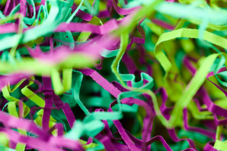 Colorful tinsel, party holiday background. Gift box decorative filler. Beautiful backdrop design for advertising.の写真素材