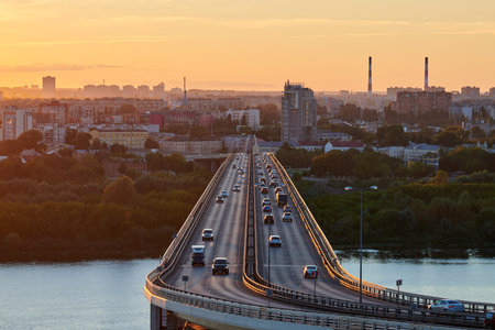 Nizhny Novgorod, Russia - 08.21.2020 - Nizhny Novgorod bridge at sunset. Rapid transit, road bridge, metro metromost over OKA river. Beautiful sunset over cityscape.のeditorial素材