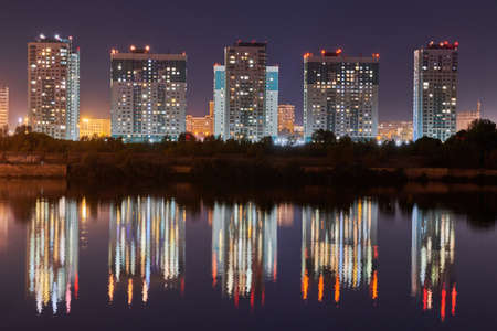 Nizhny Novgorod, Russia - 08.21.2020 - Night city buildings light on river shore. Beautiful reflection of night lights on water surface. Long exposure photography.のeditorial素材