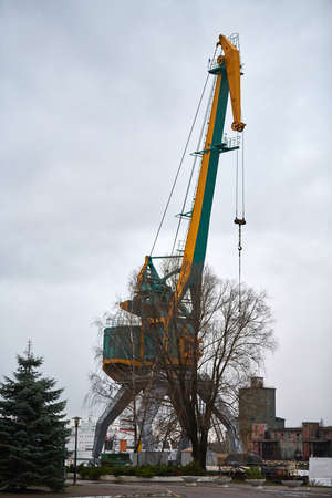 Massive harbor crane in port. Heavy load dockside crane in seaport, cargo container yard, container...