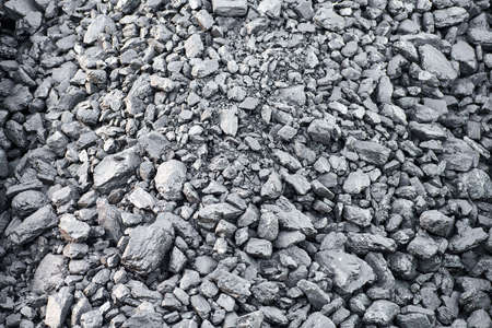 Natural black charcoal texture for background, fuel for coal industry. Top view, close up.