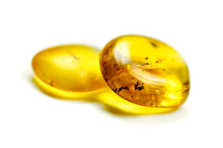Amber stones with mosquito, isolated white background. Bright yellow stone from Baltic sea. Natural...