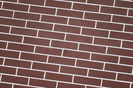 Brown brick wall with white grout lines pattern. Abstract brick texture background. New house...
