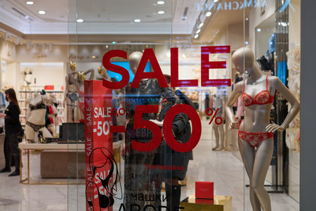 Russia, Kaliningrad - 02.15.2021 - New Year's sale time at Europe shopping center. Christmas promotions in clothing and lingerie store. Seasonal sale 50%, holiday discounts in shopping mall.のeditorial素材
