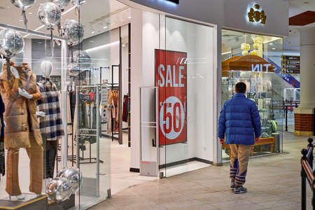 Russia, Kaliningrad - 02.15.2021 - New Year's sale time at Europe shopping center. Christmas promotions in clothing store. Seasonal sale 50%, holiday discounts in shopping mall.のeditorial素材