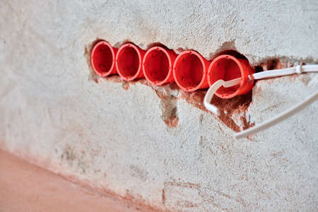 New electrical wiring installation, plastic socket boxes and electrical wires for future outlet...