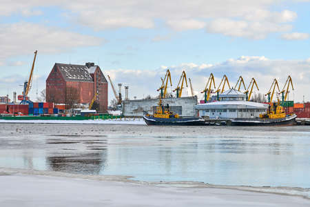 Moored cargo ships and harbor cranes in port. Seaport, cargo container yard, container ship...