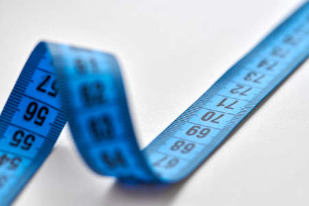Blue measuring tape of tailor isolated on white background.の写真素材