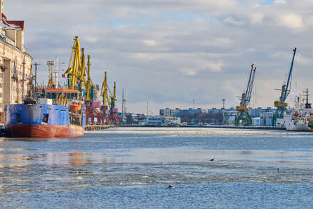Moored cargo ships and harbor cranes in port. Seaport, cargo container yard, container ship...