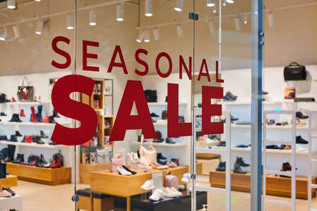 Sale time in footwear store at european shopping center. Christmas promotions in shop. Seasonal...