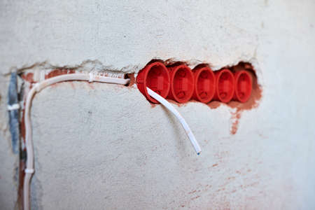 New electrical wiring installation, plastic socket boxes and electrical wires for future outlet...