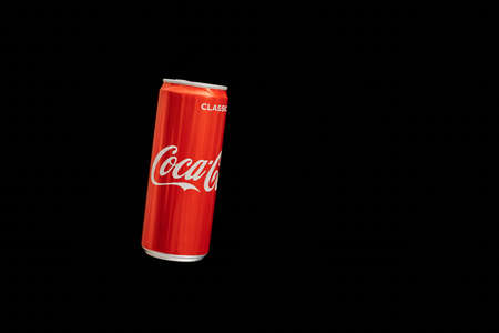 KALININGRAD, RUSSIA - MARCH 13, 2021 - Coca Cola can, black background. Classic coke jar, carbonated...