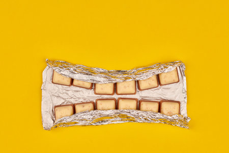 KALININGRAD, RUSSIA - 03.27.2021 - Schogetten Chocolate in foil as dental teeth concept. Delicious...