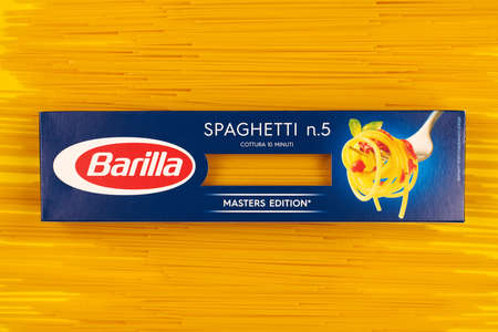 KALININGRAD, RUSSIA - 03.27.2021 - Barilla spaghetti packet, yellow background. Spaghetti n.5 master edition. Packed italian pasta.のeditorial素材
