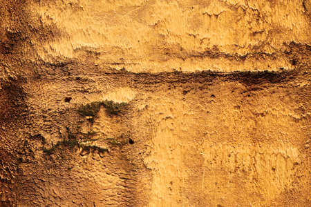 Abstract background of rough yellow wall texture, copy space. Vintage scratched and damaged grunge...