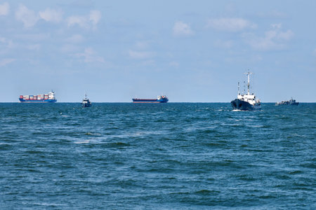 Container cargo ships in distance, import export business trade logistic and transportation, container cargo ships boats in open blue sea. Freight shipping maritime, nautical vesselの写真素材
