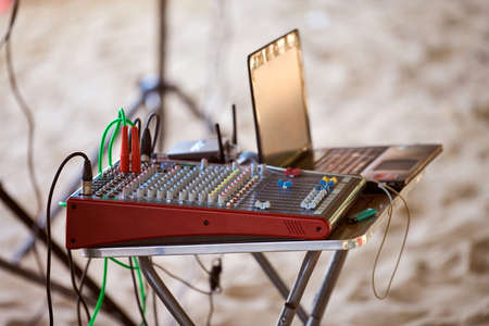 Mixing console electronic device, professional stage sound mixer at beach party, close up. Sound...