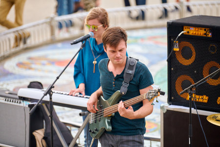 Svetlogorsk, Russia - 08.14.2021 - Bass guitar player on concert stage, live music theme. Skilled...