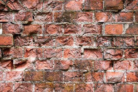 Red brick wall of old building, red brick texture, reliable brickwork masonry with bricklayer, bricks and mortar. Broken red brick building construction backgroundの写真素材