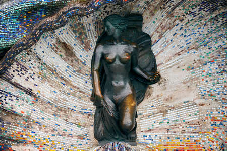 Svetlogorsk, Russia - 04.23.2022 - Bronze sculpture of Nymph girl in mosaic seashell at seaside promenade. Beautiful bronze statue of nude girl created by sculptors Hermann Brachert and Nikolai Frolovのeditorial素材