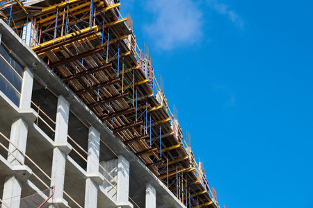 Construction of new building with reinforced concrete floors, blue sky copy space. Halted...
