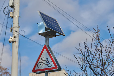 Solar panel on city road sign post, power for bus stop light, environmental friendly ecology electricity. Solar energy panel powered city infrastructure, ecological renewable solar energyの写真素材