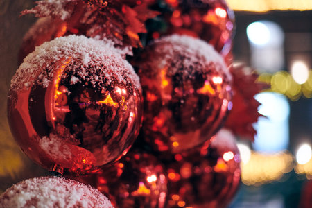 Christmas tree decorations covered snow, outdoor xmas tree with decorative red bulbsの写真素材