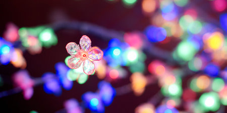 Multicolored lights bokeh from decorative luminous flowers garlands at holiday, multicolored lights